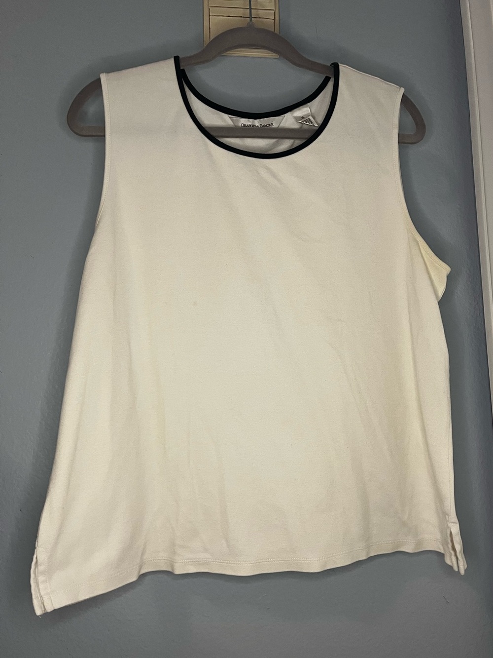 Draper's & Damon's sleeveless white tank top with black neck trip.